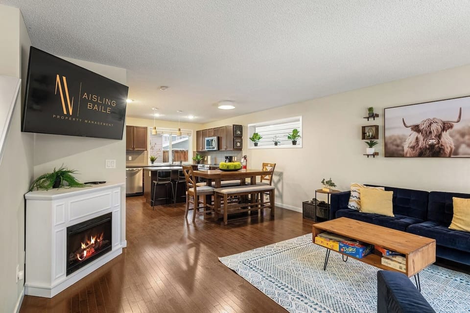 Main floor living room with a cozy couch, tons of board games, an electric fireplace, and a 55` Smart/Roku TV.