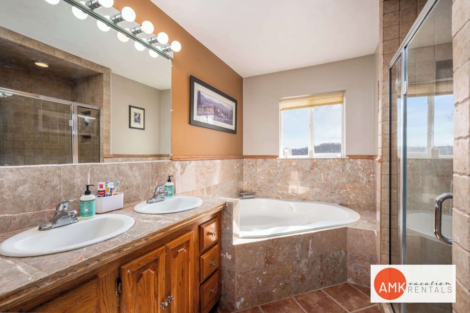 Upstairs bath with jetted tub and walk in tiled shower