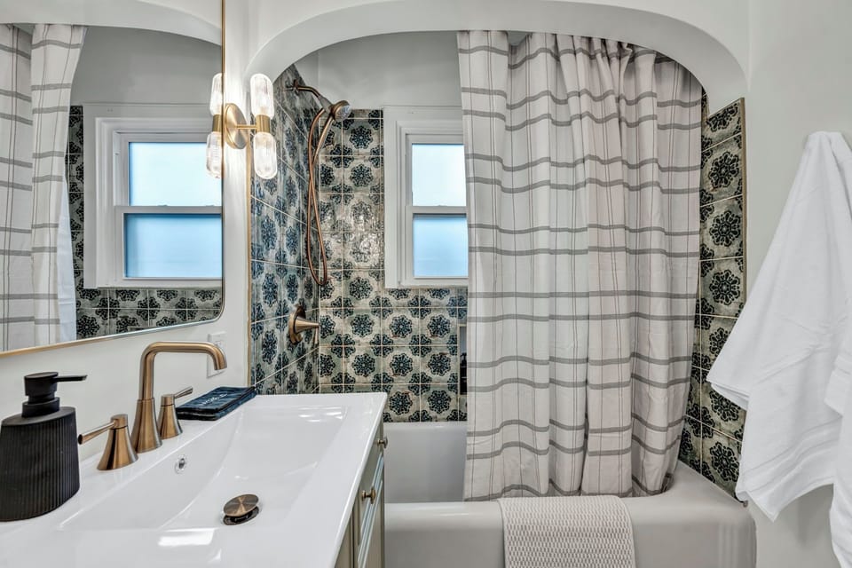 This bathroom offers a tub and shower.
