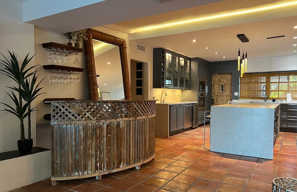 Stylish home bar area with custom wood accents and warm lighting.