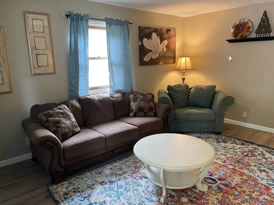 Living room with comfy chairs and smart tv with Netflix and any apps you want to log into to watch. 