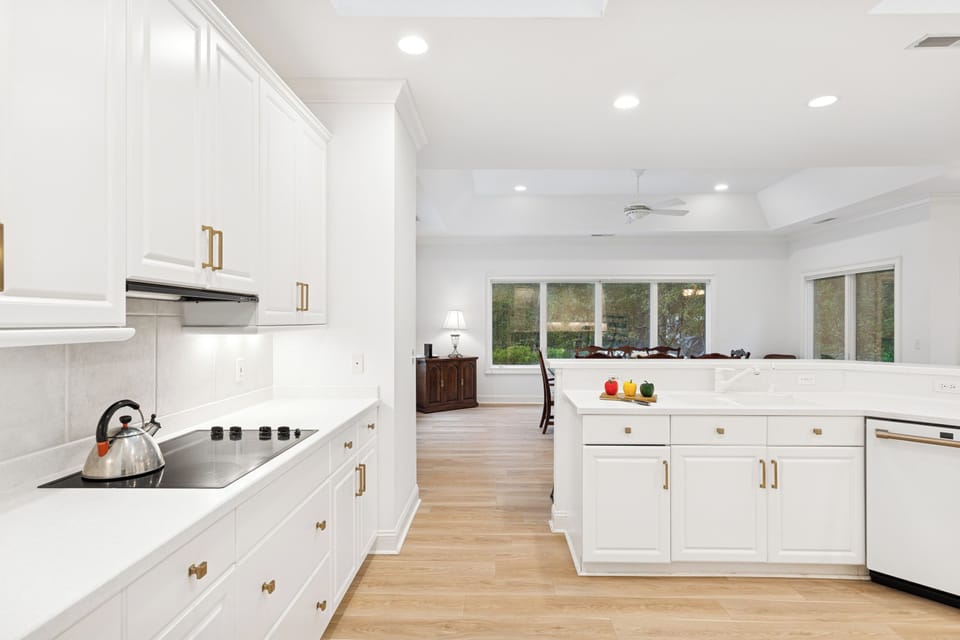Featuring sleek white cabinets and ample counter space, this is the perfect place to prepare a meal!