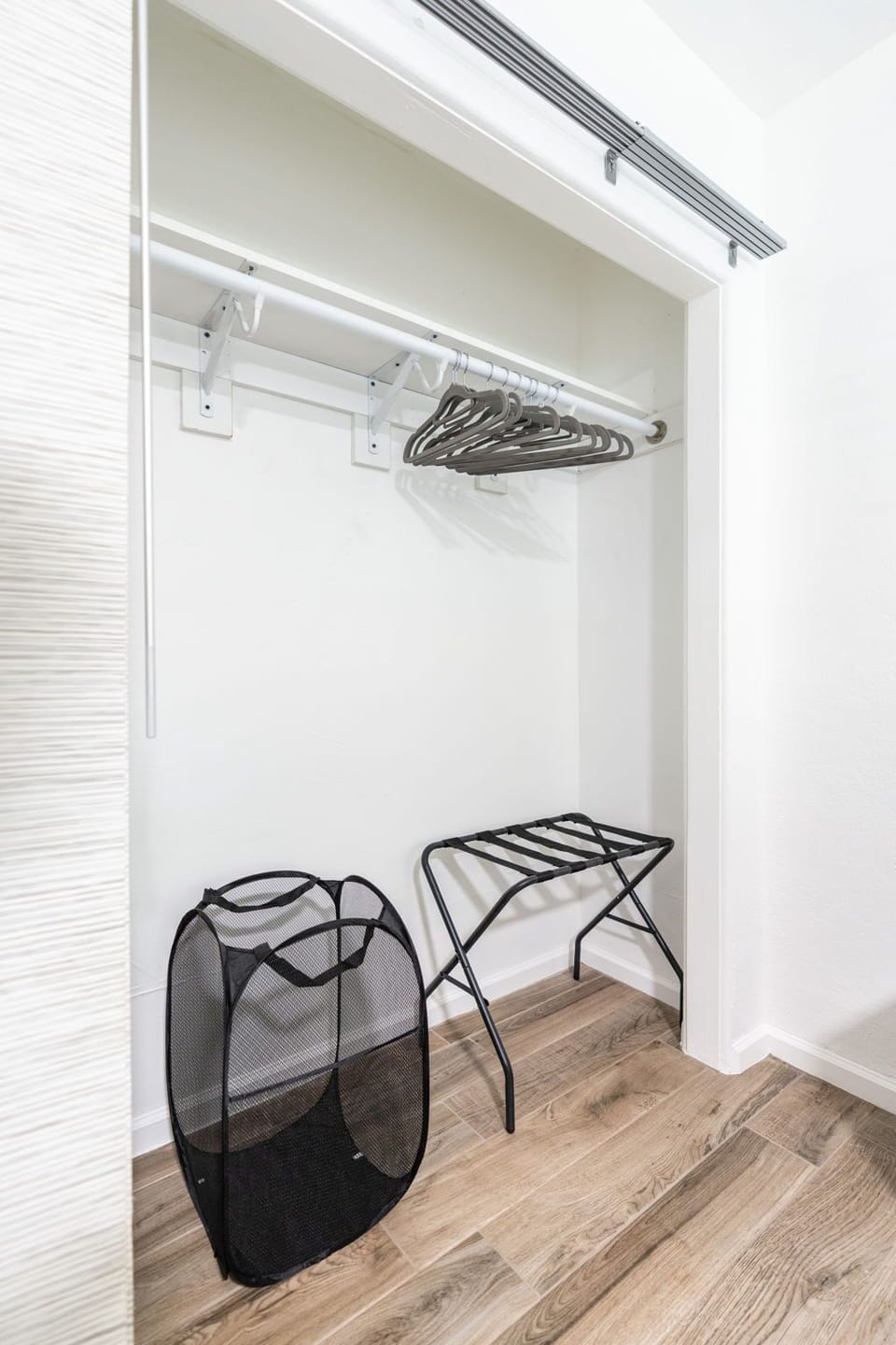 Second and third bedrooms have laundry baskets and luggage racks.