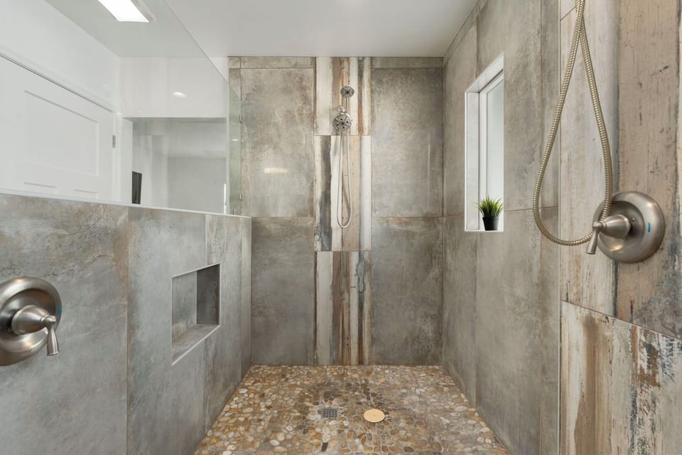 Walk in shower with two separate shower heads.