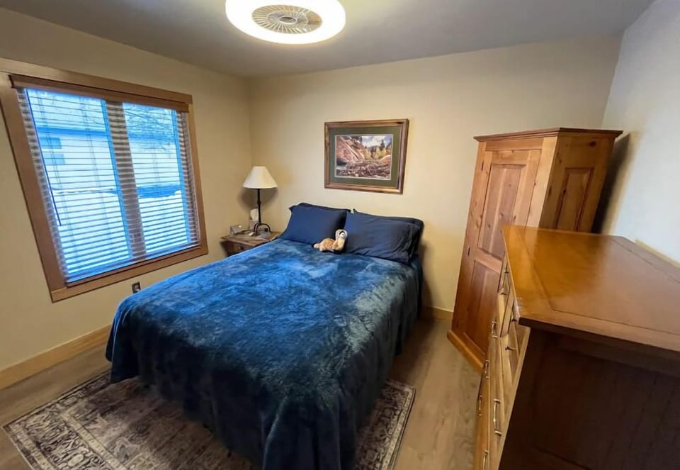Bedroom 1 features a queen bed and ample storage space.