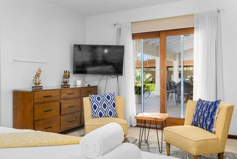 A cozy corner in the master bedroom, perfect for relaxing with a view. Enjoy easy access to the patio and pool, blending comfort and outdoor living seamlessly.