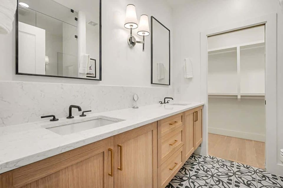 3rd Floor: Primary Bathroom featuring a dual vanity and stand-in shower.