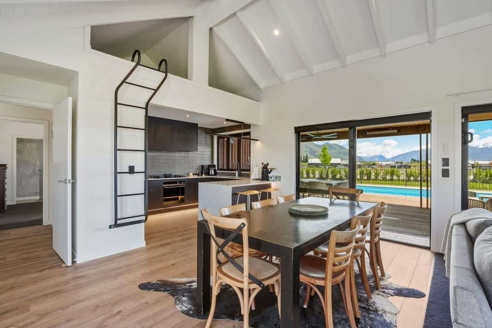 Dining and kitchen with pool view