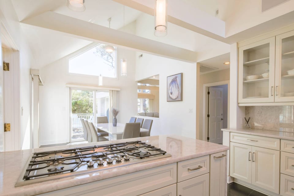 The beautiful kitchen with vaulted ceilings opens into this dining area.