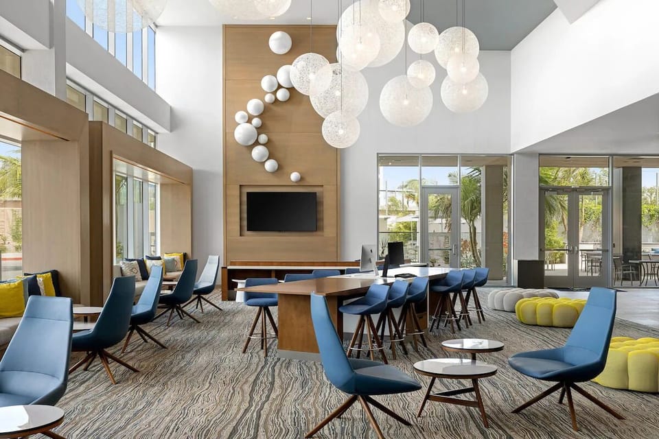 Unwind in a bright lobby lounge with stylish, airy seating.