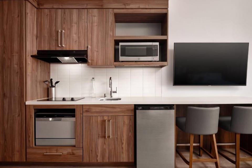 Cook and snack easily with a sleek, stocked kitchenette.