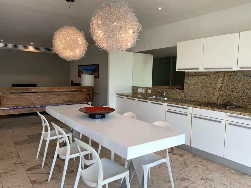 Stylish and spacious dining area with modern lighting and sleek finishes.
