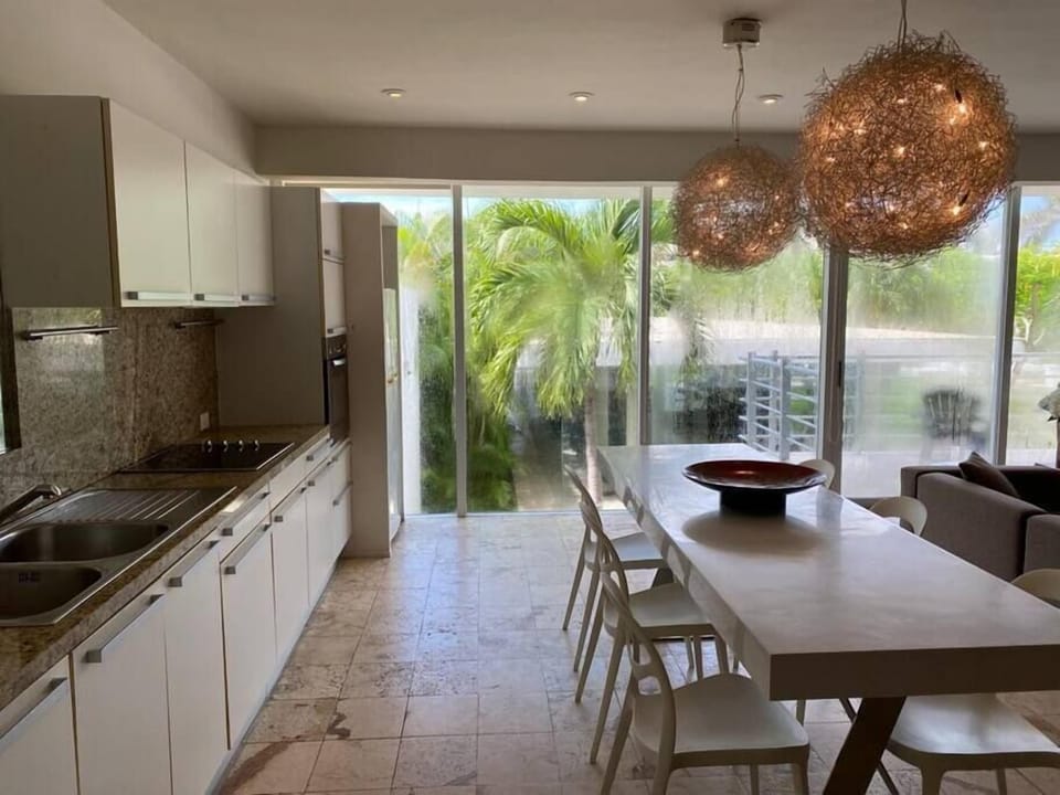 Fully equipped kitchen with garden views, ideal for cooking meals at home.