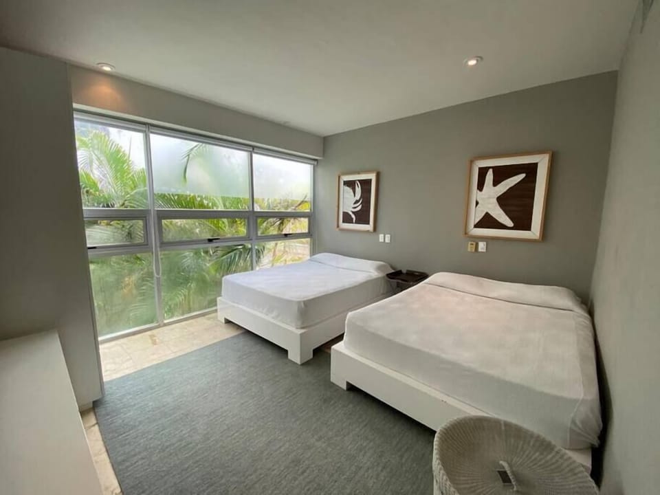 Bright and spacious second bedroom with two double beds, perfect for families.