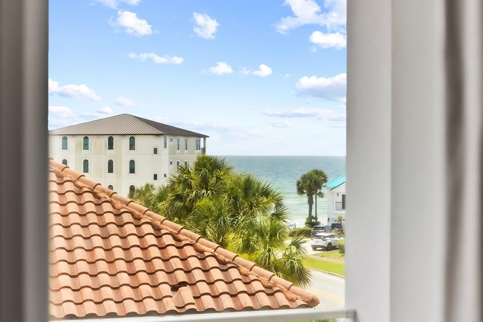 Ocean views frame your window, with swaying palms and white sand just steps away from your coastal retreat.