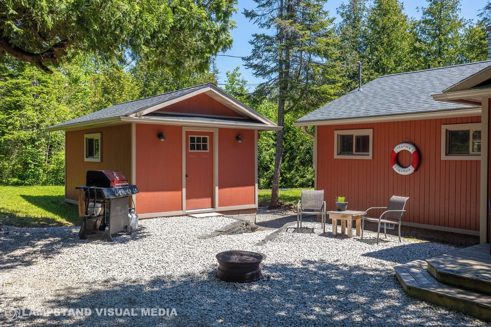 Comfortable outdoor space with a BBQ, fire pit, and chairs—perfect for outdoor dining and relaxing.