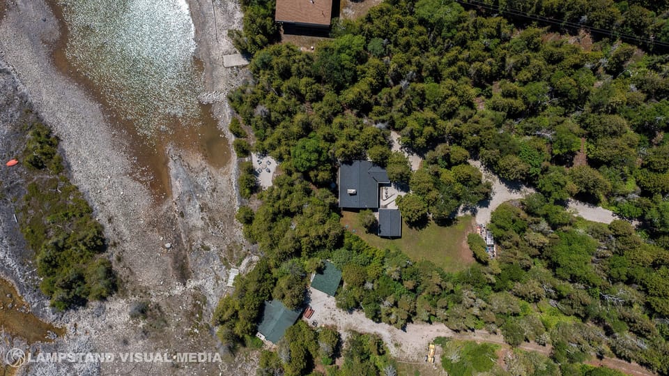 Bird’s-eye view showcasing the cottage’s private location just steps from the shoreline.