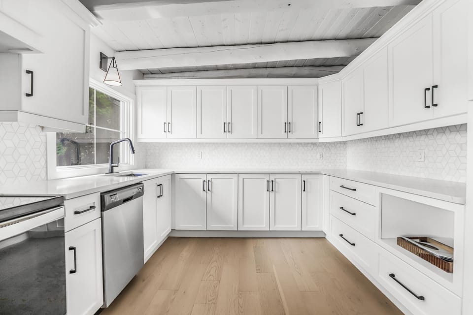 Clean white cottage kitchen with a roomy layout that makes meal prep easy.