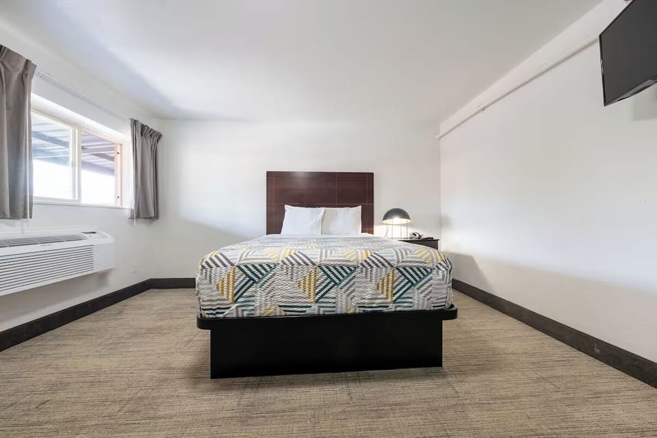 Relax into a roomy bed under soft, even lighting.