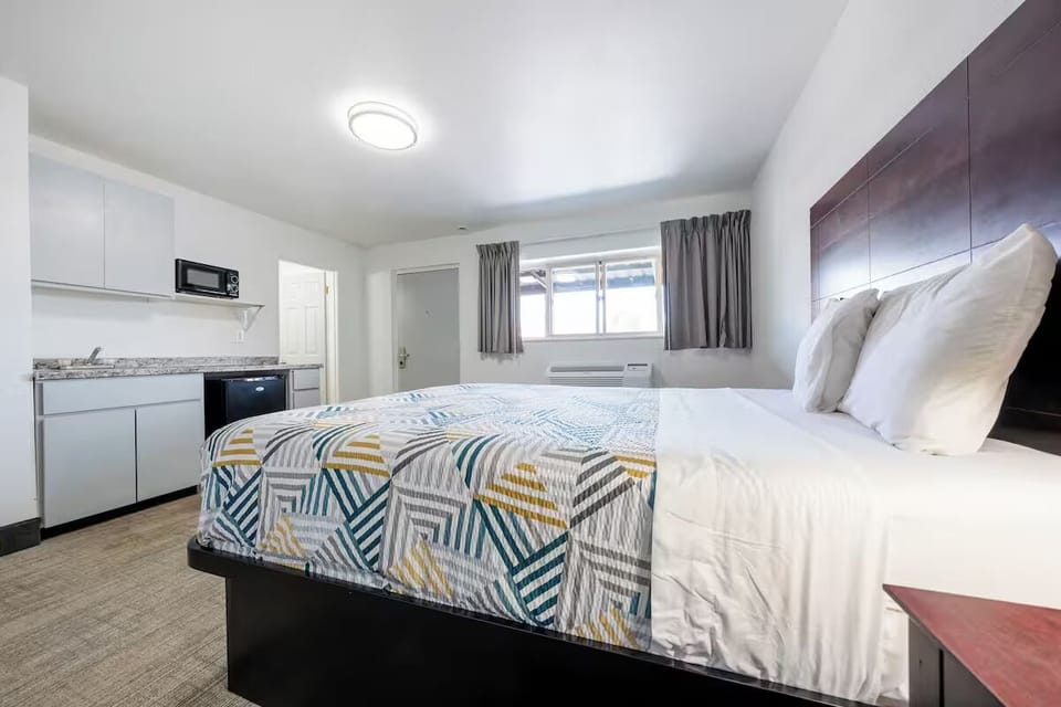 Settle into crisp linens beside an easy in-room kitchenette.
