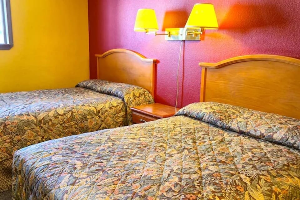 Drift off comfortably with two beds and warm bedside lighting.