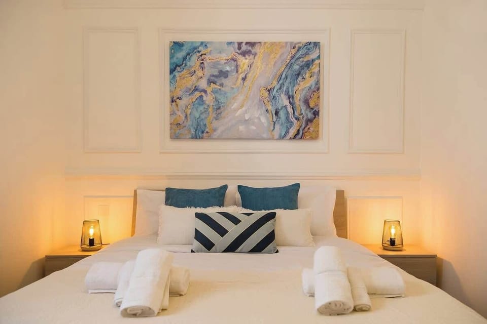 Hotel-crisp linens, generous wardrobe space and soft bedside glow - welcome to Suite 1.


