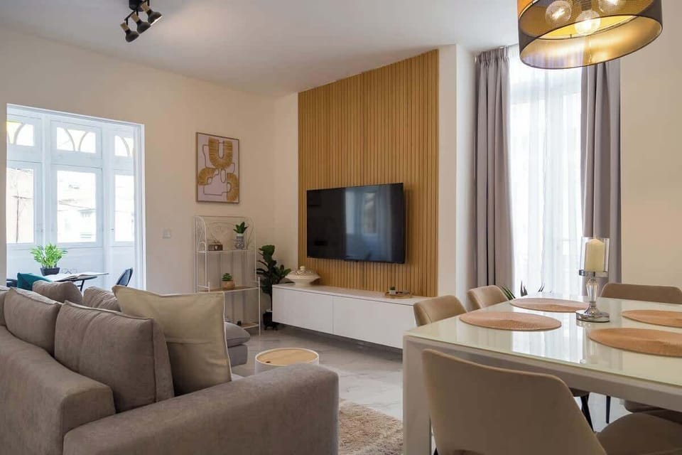 Sun-lit designer lounge with traditional Maltese Balcony – sink into the cosy sofa, stream on the Smart TV and dine under a golden pendant, all bathed in warm balcony light.
