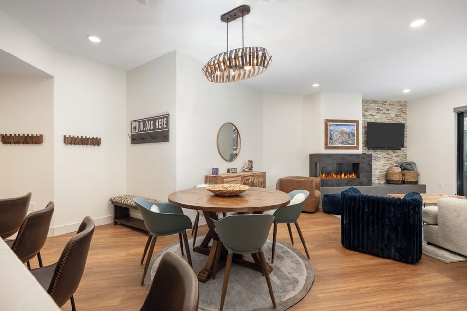 Relax in your stylish dining space with modern furnishings, then unwind by the cozy fireplace in the elegant living area.