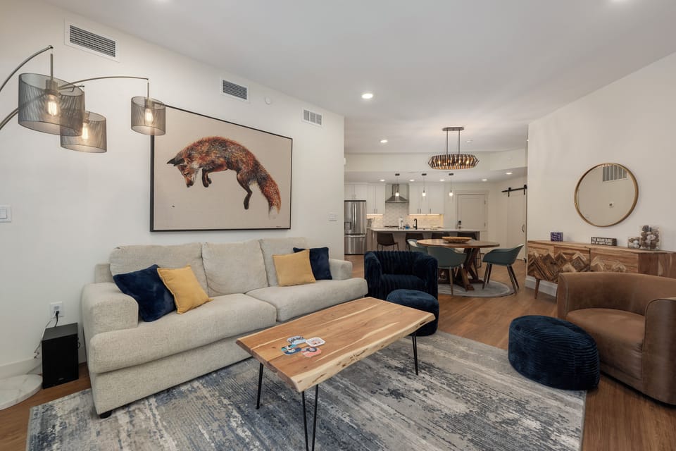 Sink into plush modern comfort where your cozy living space flows seamlessly into a fully-equipped kitchen for memorable gatherings.