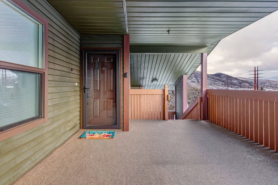 This covered entrance features a welcoming front door with mountain views framing the property's peaceful location in the surrounding area.