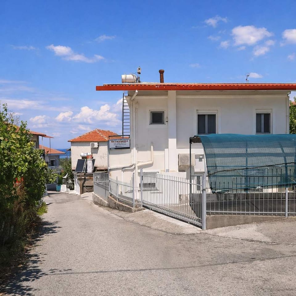 Exterior view of the property, quiet residential setting with parking