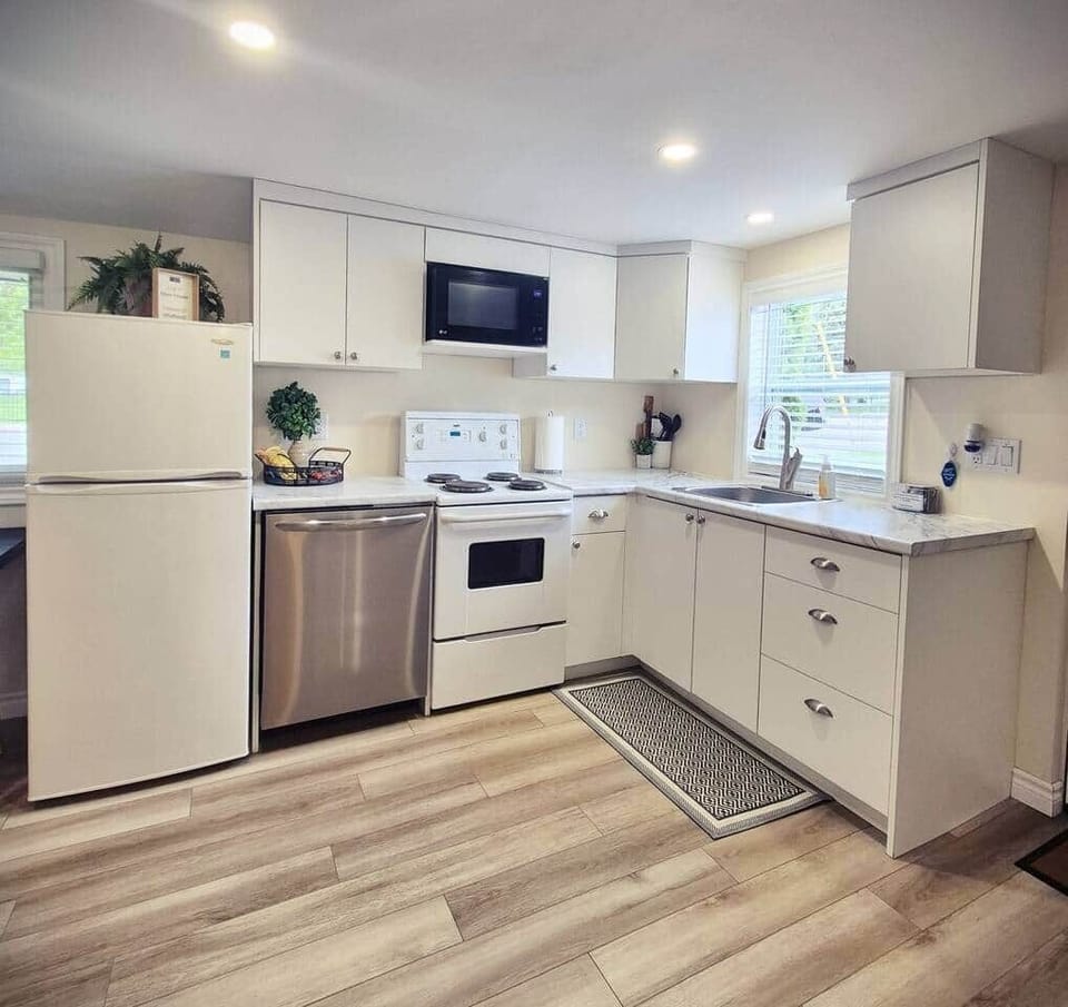 Full kitchen, featuring an oven/stove, microwave, fridge/freezer and dishwasher.