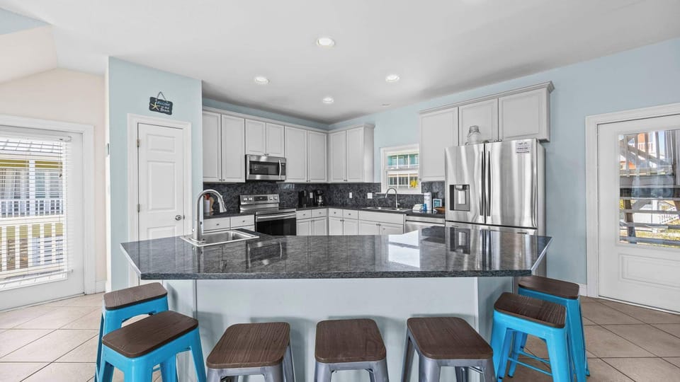 Cook, chat, and dine together around the sunlit 7-seat kitchen island.