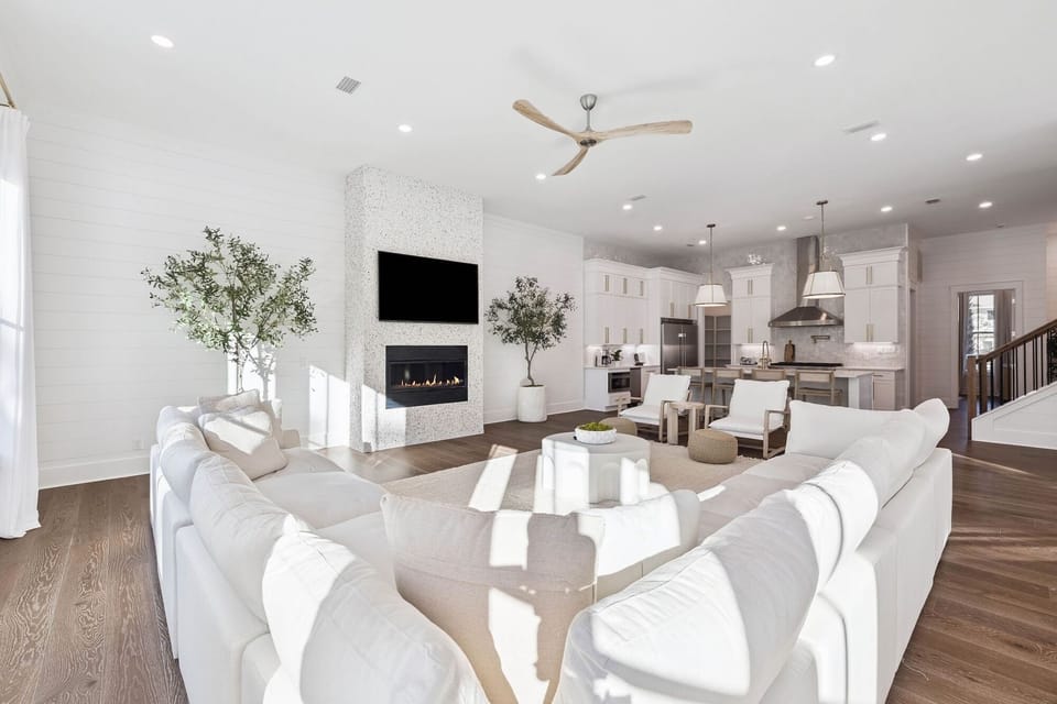 Unwind in this bright, open living space where modern comfort meets elegant design. Plush seating surrounds the fireplace for cozy evenings.
