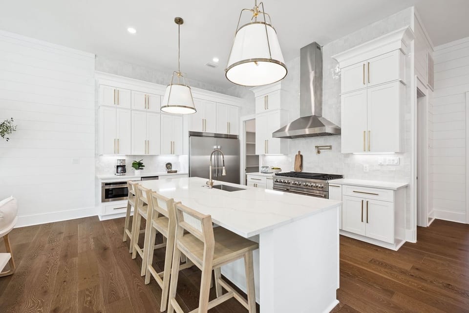 You'll love cooking in this bright, modern kitchen with pristine white cabinets, sleek countertops, and professional-grade appliances for memorable meals.