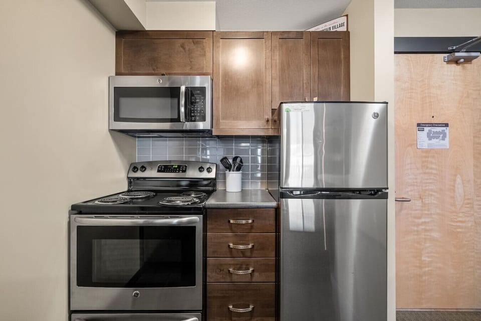 Full kitchen with a drip coffee maker, ground coffee, tea, sugar, and basic condiments (ketchup, mustard & relish.)