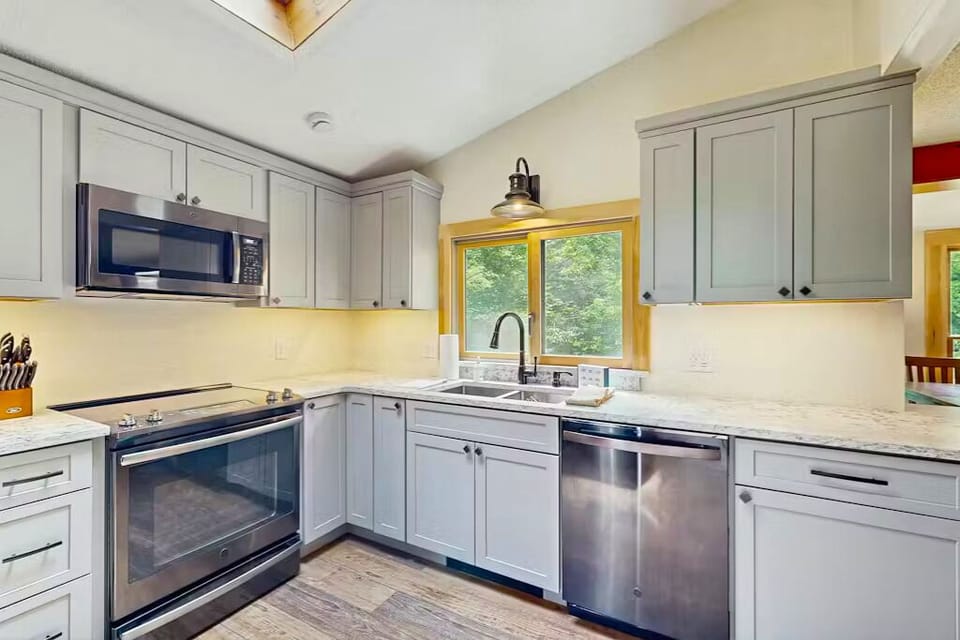 Bright modern kitchen with stainless appliances and views—fully equipped