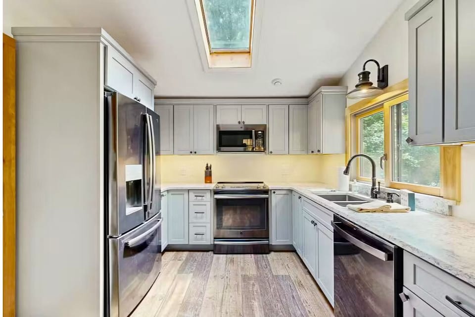 Modern kitchen with stainless appliances and skylight—your NoCo cooking haven.