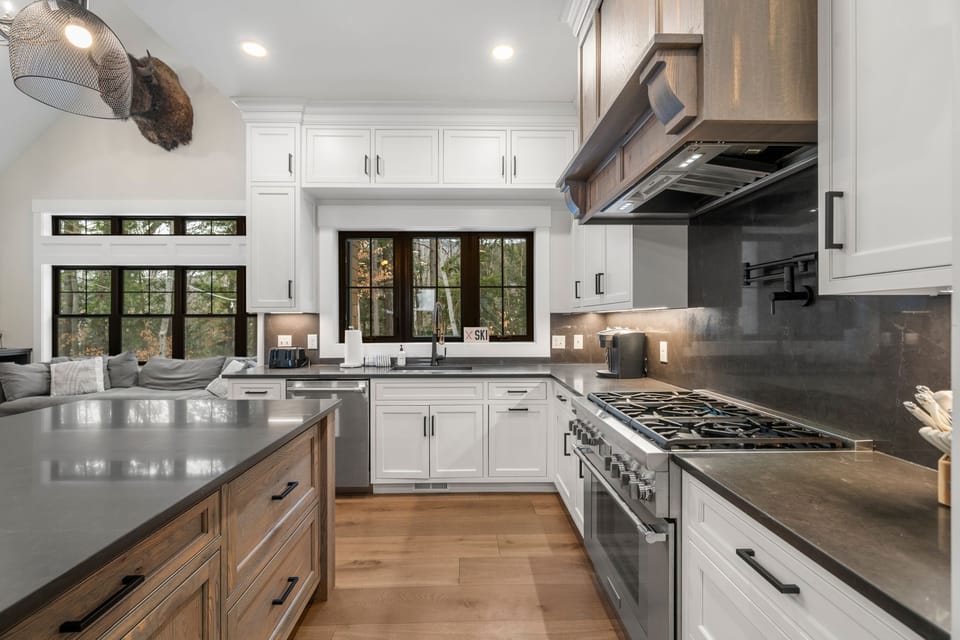 Fully equipped kitchen with modern appliances, spacious island & seating for 5.