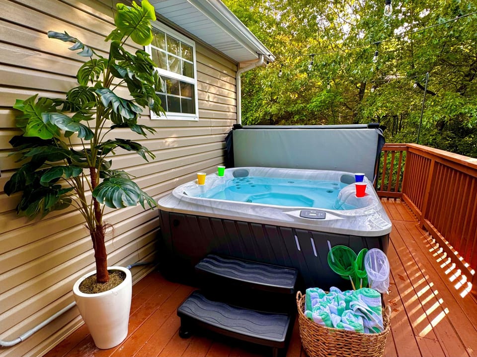 Indulge in a refreshing soak in the hot tub surrounded by nature'