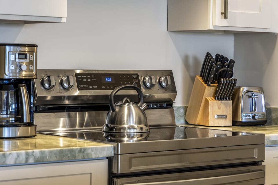 Fully equipped kitchen with modern stainless steel appliances