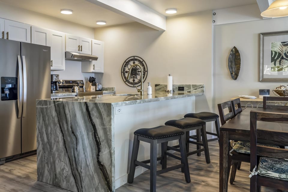 Modern kitchen and dining area with sleek marble island seating