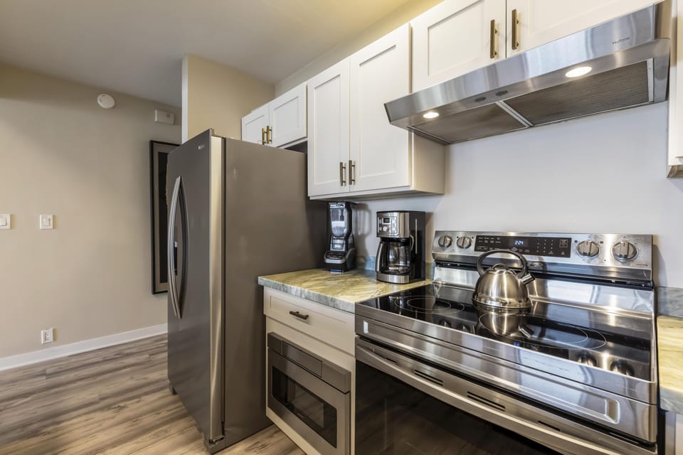 Modern kitchen with stainless steel appliances and cozy lighting
