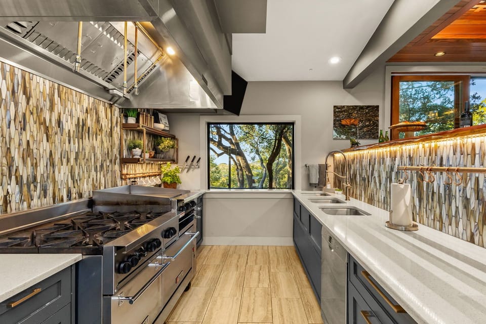 Chef's Kitchen, featuring a commercial-grade range, griddle, & double prep sinks