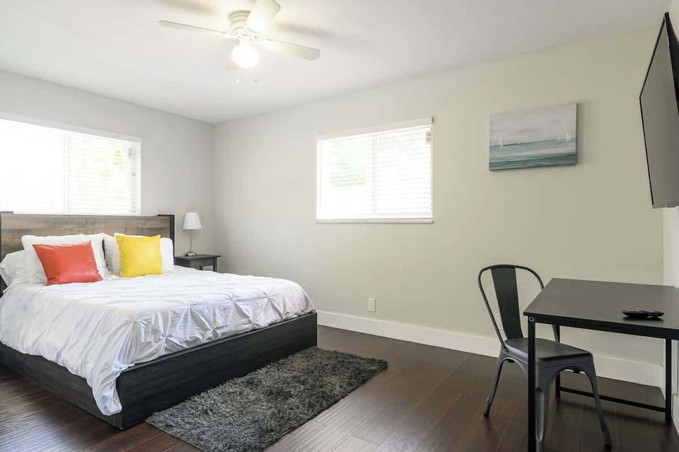 "Sleep, stream, or work in this bright, modern bedroom with smart TV and desk—perfect for couples, solo travelers, or remote work stays. Your cozy vacation rental awaits!"