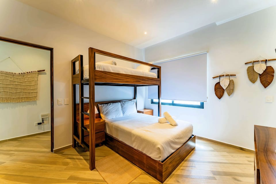 Familly Room | A functional yet stylish room featuring bunk beds, streaming TV, and easy access through a second entrance.