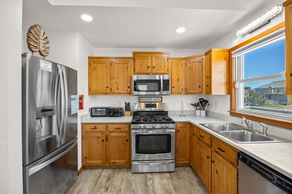 The kitchen is fully equipped with stainless steel appliances and ample counter space.