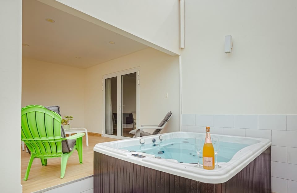Bubbles in the tub, bubbles in the glass. Pop open a bottle, sink into the warm jets, and let the world melt away. Your private jacuzzi is always ready — day or night. This is what a real vacation feels like.