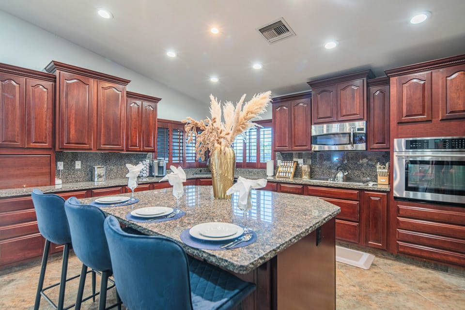 Large granite island with bar seating, perfect for meals and gathering