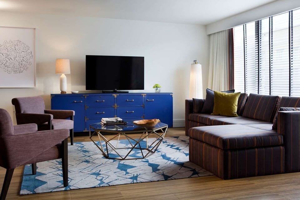 Gather in the airy living room, steps from bed.